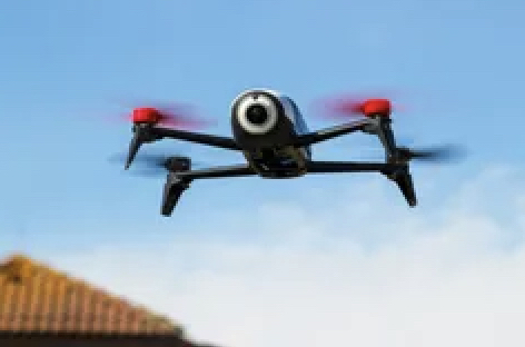 Drone flying over a house roof.